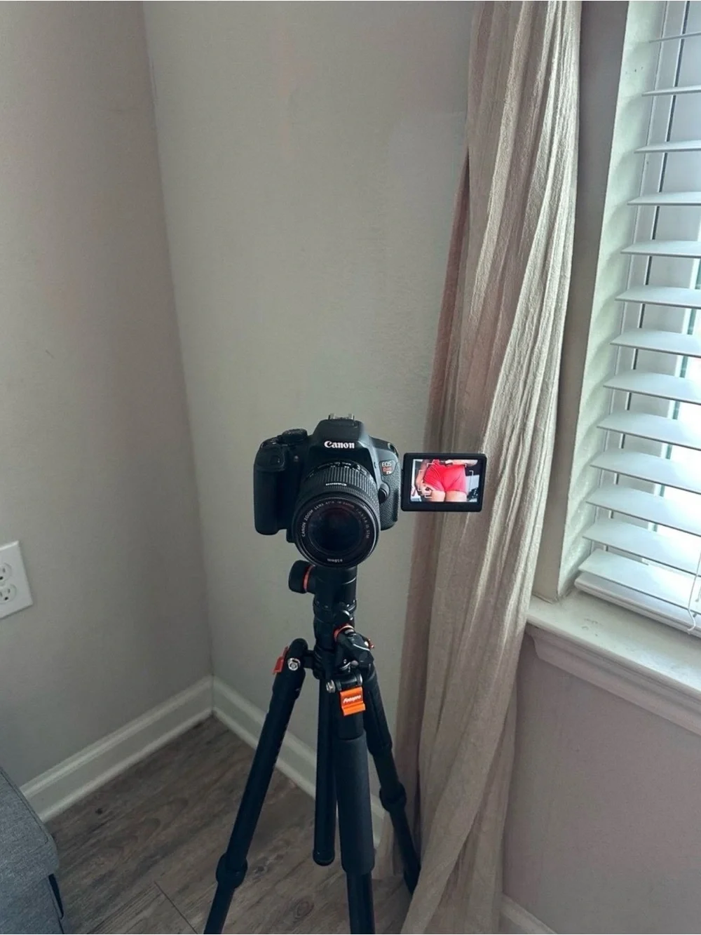 Canon Black DSLR Camera with Rotating LCD and Black Tripod